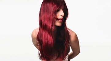 Model with long, glossy, cherry red hair.