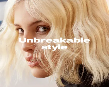 Model with short, blonde wavy hair looking to the side, Text overlay reads 'Unbreakable style'.